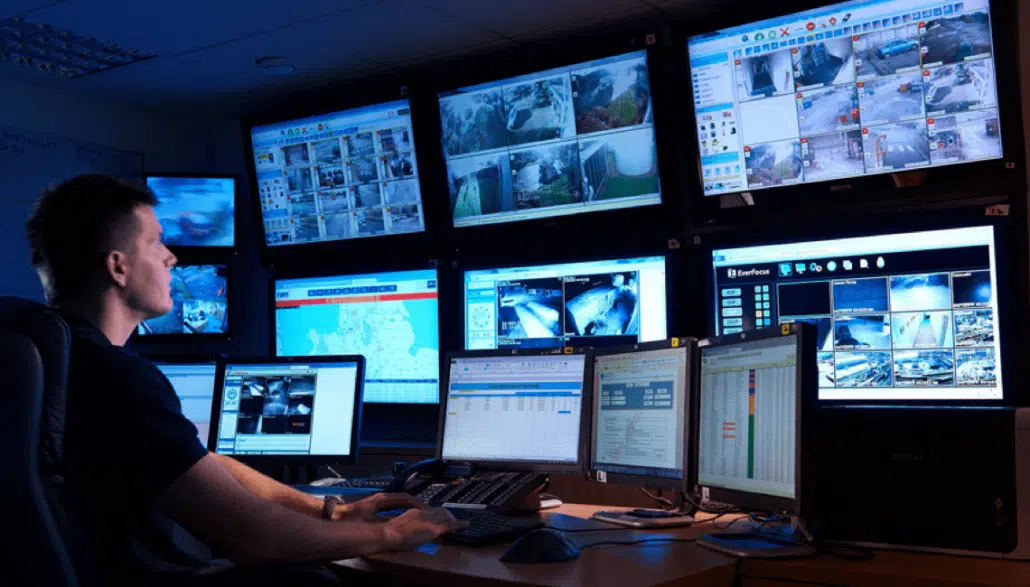 Security technician monitoring video surveillance feeds