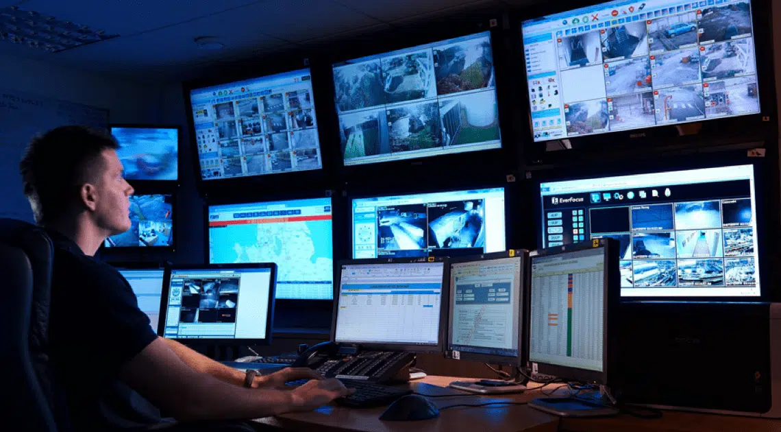 Security technician monitoring video surveillance feeds